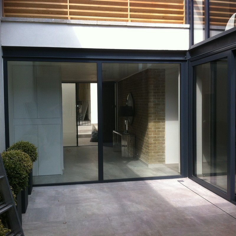 Floor-to-ceiling sliding doors opening to courtyard in Manor Park