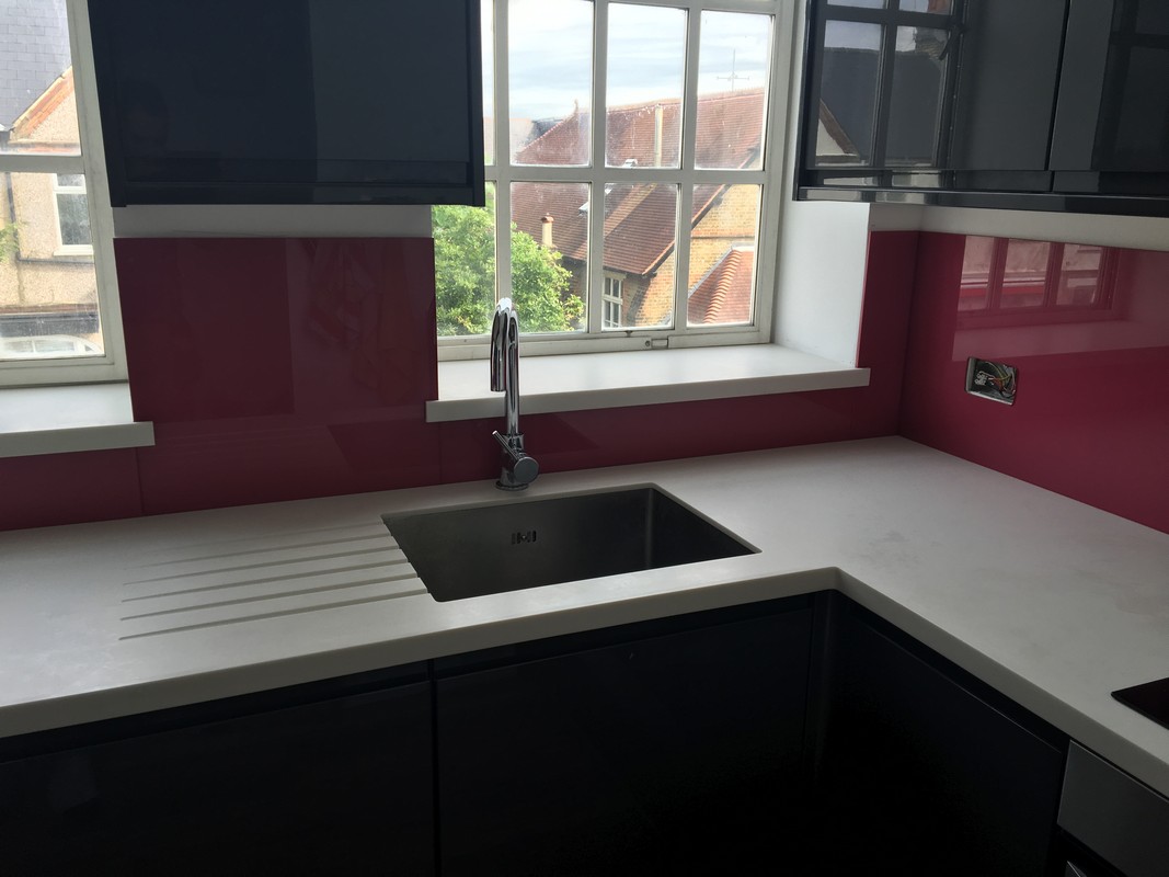 Deep plum coloured glass splashback in modern Manor Park kitchen